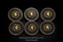 Charger l'image dans la galerie, Six decorative metal buttons with a central emblem, authenticated by V&A Museum, on a black background.