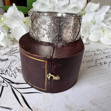 Load image into Gallery viewer, Antique Victorian Aesthetic Engraved Rose & Lily Sterling Silver Bangle In Original Maroon Leather Drum Shaped Bracelet Case, Dated 1883