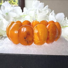 Load image into Gallery viewer, Antique Genuine Baltic Amber Panel Bracelet. Art Deco Carved Egg Yolk Amber Stretch Bracelet. Natural Untreated Amber Bracelet
