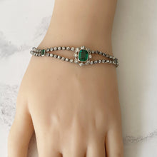 Load image into Gallery viewer, Antique Art Deco Paste Diamond &amp; Emerald Bracelet. 1920s Sterling Silver Articulated Bracelet. Emerald Cut Green Gemstone Bracelet.
